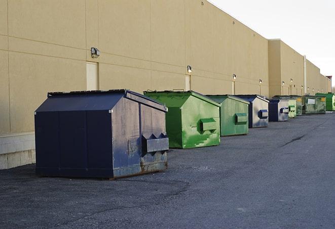 a crowd of dumpsters of all colors and sizes at a construction site in Gardendale